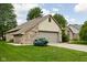 Beautiful brick home with a two-car garage, well-maintained lawn, and mature landscaping at 842 Cheltenham Way, Avon, IN 46123
