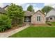 Inviting brick home featuring a charming front porch and a well-manicured lawn at 842 Cheltenham Way, Avon, IN 46123