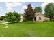 Expansive front yard with mature trees offering shade and curb appeal to the beautiful brick home at 842 Cheltenham Way, Avon, IN 46123