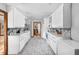 Bright kitchen with white cabinets, gray backsplash, and stainless steel appliances at 842 Cheltenham Way, Avon, IN 46123