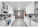 Bright kitchen featuring white cabinets, subway tile backsplash, and modern appliances at 842 Cheltenham Way, Avon, IN 46123