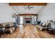 Spacious living room boasting a vaulted ceiling, wood floors, and a cozy brick fireplace at 842 Cheltenham Way, Avon, IN 46123