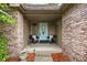 Charming front porch features a cozy seating area with stylish decor and brick accents at 842 Cheltenham Way, Avon, IN 46123