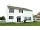 Exterior view of a large two-story home featuring a well-maintained lawn, white picket fence, and brick-red shutters at 8519 Frosty Rose Dr, Avon, IN 46123