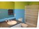 Colorful bathroom with a combination of yellow and blue on the walls and a shower and tub combination at 8519 Frosty Rose Dr, Avon, IN 46123