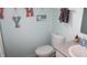 Bright bathroom with a white toilet, grey countertop and light blue walls at 8519 Frosty Rose Dr, Avon, IN 46123