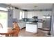 Bright eat-in kitchen with white cabinets, stainless steel appliances, an island, and wood flooring at 8519 Frosty Rose Dr, Avon, IN 46123