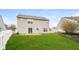 Large backyard with green grass, vinyl fencing, and a two-story house at 9220 Crossing Dr, Fishers, IN 46037