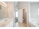 Clean, bright bathroom featuring double vanity, soaking tub, and neutral color palette at 9220 Crossing Dr, Fishers, IN 46037