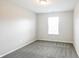 Carpeted bedroom with light neutral walls and window for natural lighting at 9220 Crossing Dr, Fishers, IN 46037