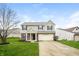 Charming two-story home with gray siding, brick accents, and a well-maintained lawn at 9220 Crossing Dr, Fishers, IN 46037