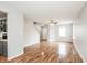 Open-concept living room featuring hardwood floors, ceiling fan and neutral color palette at 9220 Crossing Dr, Fishers, IN 46037