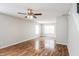 Bright and airy living area with hardwood floors and a modern ceiling fan at 9220 Crossing Dr, Fishers, IN 46037
