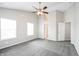 Spacious main bedroom featuring a ceiling fan, carpet flooring, and bright windows at 9220 Crossing Dr, Fishers, IN 46037