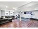 Spacious finished basement with wood-look floors, a gray sofa, and a home gym area at 9302 Budd Run Dr, Indianapolis, IN 46250