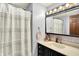 This bathroom features a large vanity with a dark cabinet and light counter and dark fixtures at 9302 Budd Run Dr, Indianapolis, IN 46250