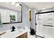 This gray bathroom features a new vanity, fixtures, toilet, walk in shower and window at 9302 Budd Run Dr, Indianapolis, IN 46250
