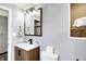The gray bathroom features a new vanity with black fixtures, a toilet, a window and extra towels at 9302 Budd Run Dr, Indianapolis, IN 46250