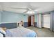 Spacious bedroom with carpet, ceiling fan, and a closet with wooden door at 9302 Budd Run Dr, Indianapolis, IN 46250