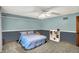 Blue bedroom featuring neutral carpet and a ceiling fan for added comfort at 9302 Budd Run Dr, Indianapolis, IN 46250