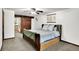 Bedroom featuring a sliding barn door, ceiling fan, and a cozy atmosphere at 9302 Budd Run Dr, Indianapolis, IN 46250