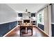 Formal dining room with beautiful wood floors, a fireplace with built-in shelves, and natural light from a large window at 9302 Budd Run Dr, Indianapolis, IN 46250
