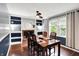 Elegant dining room featuring wood floors, a fireplace with built-in shelving, and ample natural light from large windows at 9302 Budd Run Dr, Indianapolis, IN 46250