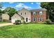 Beautifully maintained two-story home with a lush green lawn, two-car garage, and inviting curb appeal at 9302 Budd Run Dr, Indianapolis, IN 46250