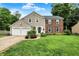 Charming two-story home featuring a blend of brick and siding, a well-manicured lawn, and an attached two-car garage at 9302 Budd Run Dr, Indianapolis, IN 46250