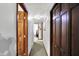 Hallway with neutral colored walls and carpet flooring and wooden doors at 9302 Budd Run Dr, Indianapolis, IN 46250
