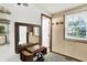 This hallway has a large window and antique sewing table as an accent piece at 9302 Budd Run Dr, Indianapolis, IN 46250