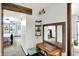 Hallway view features natural light, neutral paint, and an antique sewing table at 9302 Budd Run Dr, Indianapolis, IN 46250