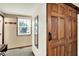 View of wooden sliding door, gray carpet and mirror in the hallway of this charming home at 9302 Budd Run Dr, Indianapolis, IN 46250