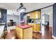 Functional kitchen with an island offering views into an office space and a living area. Lots of cabinets for storage at 9302 Budd Run Dr, Indianapolis, IN 46250