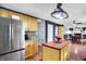 Spacious kitchen with stainless steel appliances, warm wooden cabinets, and a view to the adjacent dining area at 9302 Budd Run Dr, Indianapolis, IN 46250