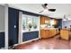 Open-plan kitchen area with wood floors, large window with backyard views, and stylish blue accent wall at 9302 Budd Run Dr, Indianapolis, IN 46250