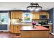 Bright kitchen featuring an island, stainless steel appliances, tile backsplash and garden window for natural light at 9302 Budd Run Dr, Indianapolis, IN 46250