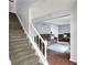 Open living room featuring hardwood floors, neutral walls, and a comfortable seating area with a view of the entry at 9302 Budd Run Dr, Indianapolis, IN 46250