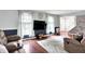 Bright living room with hardwood floors, large windows, and a comfortable seating area at 9302 Budd Run Dr, Indianapolis, IN 46250