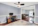 Cozy office featuring a modern desk setup, plush rug, and a glimpse into the comfortable living room space at 9302 Budd Run Dr, Indianapolis, IN 46250
