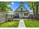 Private, fenced backyard with a patio perfect for outdoor seating, complemented by lush greenery and a dog house at 938 N Tuxedo St, Indianapolis, IN 46201