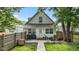 Private, fenced backyard with a patio perfect for outdoor seating, complemented by lush greenery and a dog house at 938 N Tuxedo St, Indianapolis, IN 46201