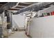 Unfinished basement space with stairs and visible ductwork offers potential for storage or customization at 938 N Tuxedo St, Indianapolis, IN 46201