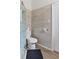 Updated bathroom boasts tiled walls, new toilet, sleek hardware, and stylish finishes at 938 N Tuxedo St, Indianapolis, IN 46201