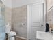 Bright bathroom with tiled walls, new sink, toilet, updated fixtures, and modern finishes at 938 N Tuxedo St, Indianapolis, IN 46201