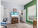 Bedroom with a bathroom, exercise bike, television and small desk with books at 938 N Tuxedo St, Indianapolis, IN 46201
