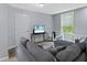 Living room featuring a comfortable gray sofa, window and natural light at 938 N Tuxedo St, Indianapolis, IN 46201