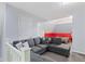 Cozy living room showcasing gray sofa sectional, white stair railing, and open bedroom at 938 N Tuxedo St, Indianapolis, IN 46201