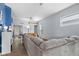 Open living area featuring an expansive sectional sofa, natural light, and wood floors at 938 N Tuxedo St, Indianapolis, IN 46201