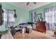 Cozy bedroom with hardwood floors, a window offering natural light, and mint-green walls at 952 Lasalle St, Indianapolis, IN 46201